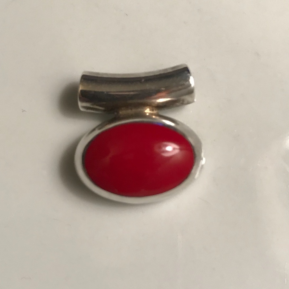 Sterling silver and red stone pendant.